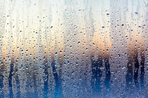 A foggy window at sunset as an abstract background.