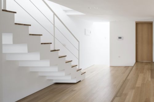 white empty living room with stair, window, pendant lighting, stair at the day.